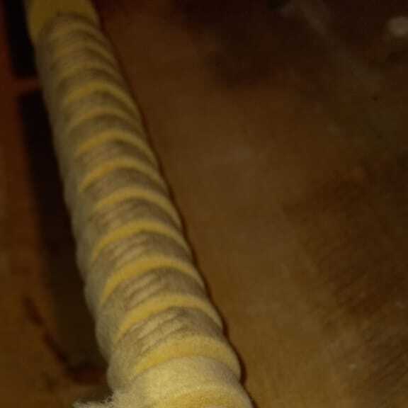 Removing the string grooves from a grand piano's hammers through refacing.