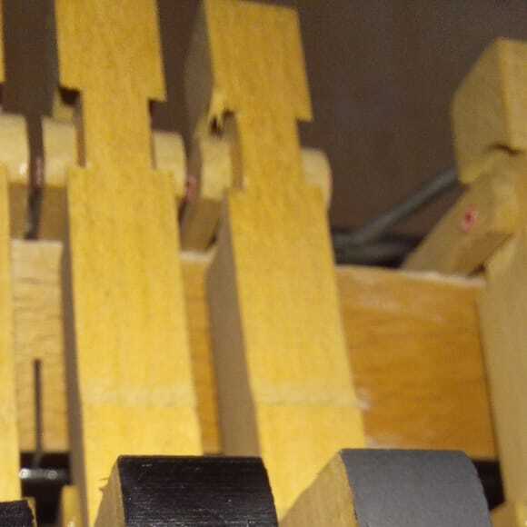 Burnishing the newly-applied graphite on a Bechstein's whippen heels.